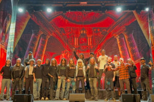 End of tour group photo featuring members of BLOODSTAIN, Dark Tranquillity, Múr, and the Dark Tranquillity touring crew on stage at Filmstudion in Gothenburg, October 18, 2025. Photo by Alex Hellid (LXL).